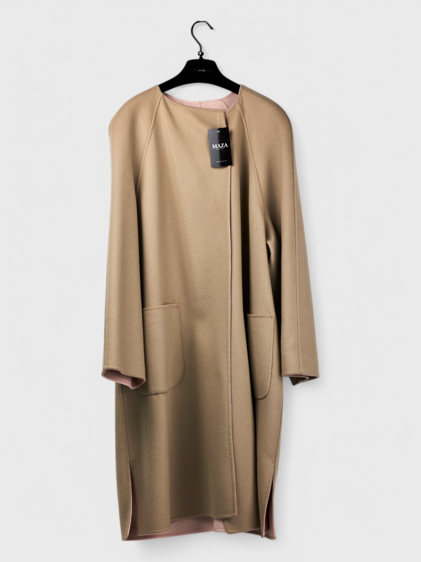 Reversible pink and cappuccino spring coat with open front and pockets, size 48, hanging on a hanger, tag attached