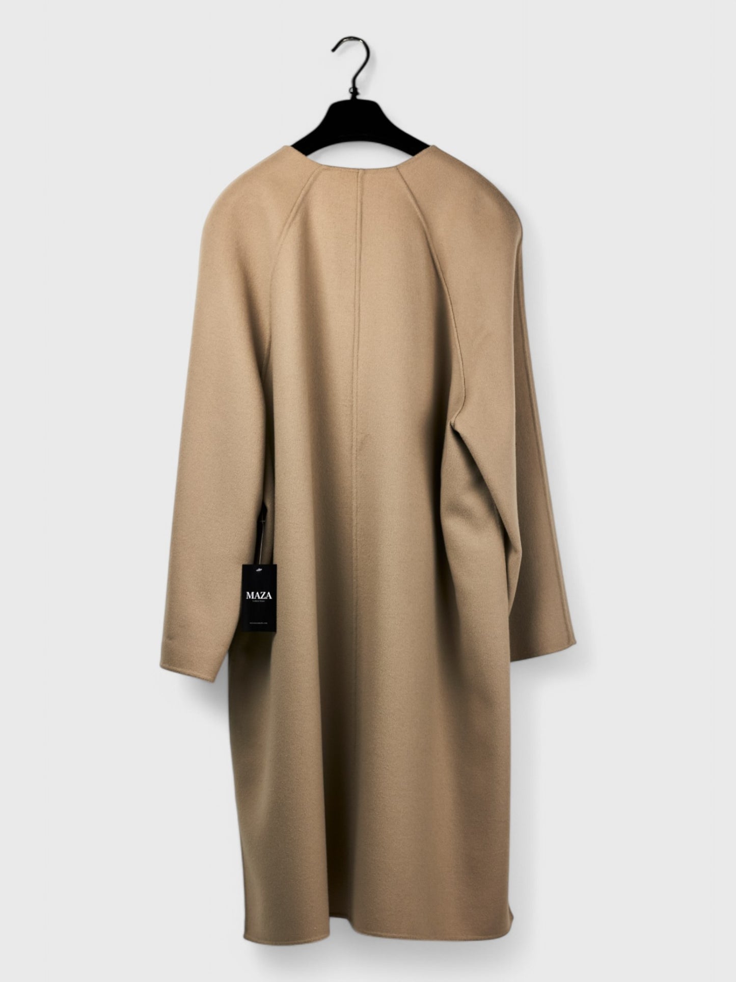 Back view of reversible pink and cappuccino spring coat size 48 showing cappuccino side with long sleeves and tag attached, hanging on a hanger