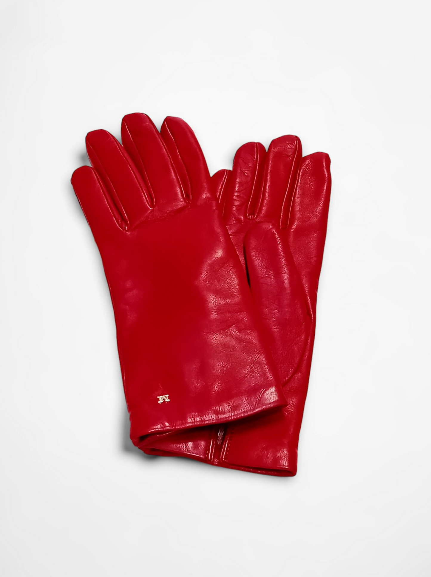 Pair of shiny red leather gloves on a white background